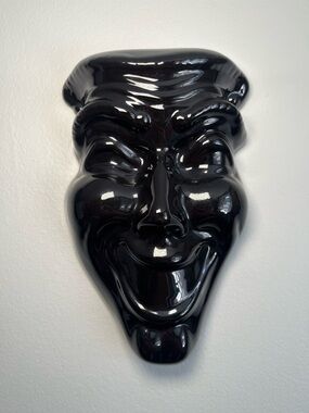Vintage black ceramic "Smile Now Cry Later" decorative mask.